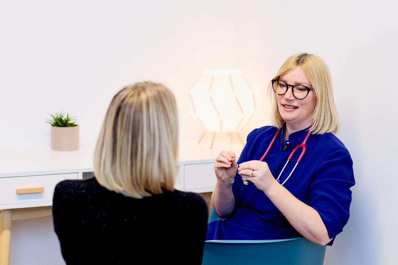 Dr Lorraine Kemp speaking with a patient during a skincare consultation